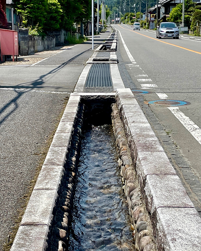 用水路を清らかな水が流れ落ちる写真